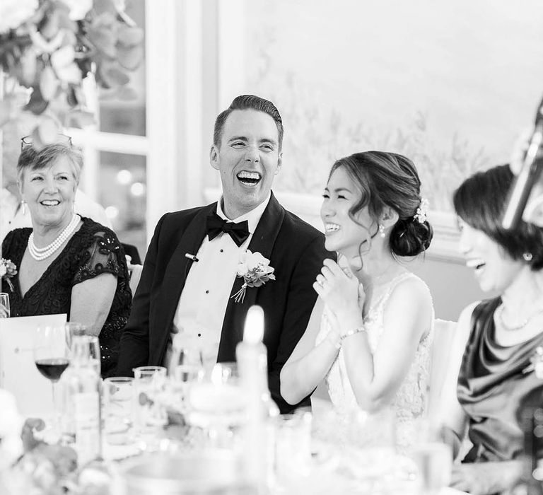 Black & white image of bride & groom during wedding reception