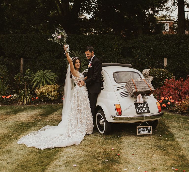 White Fiat 500 wedding car, white sleeveless wedding dress and long veil