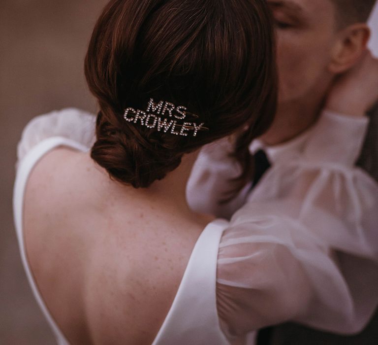 Bride wears customised diamanté hair clip accessory in her updo hairstyle 