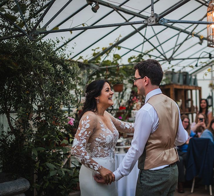 Bride & groom during first dance moment at the West Green House surrounded by colourful florals 