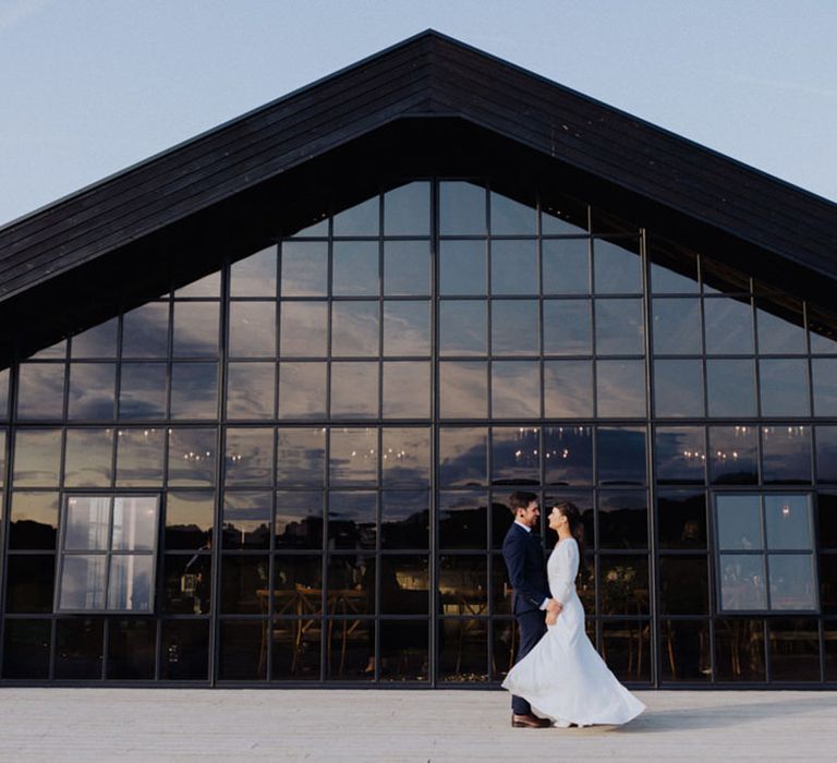 The Barn at Botley Hall wedding venue with bride and groom taking a couple portrait shot 