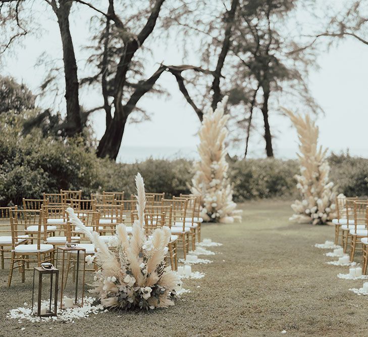 Pampas grass wedding flowers complete with arch for outdoor wedding ceremony in Phuket with muted tones throughout