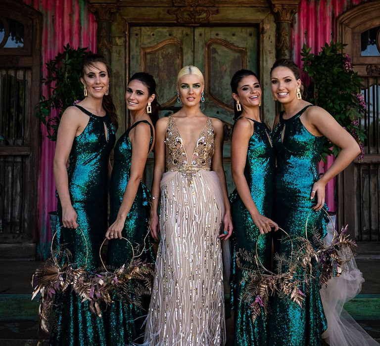 Bride in a white and gold sequin wedding dress with the bridesmaids in sequinned green dresses