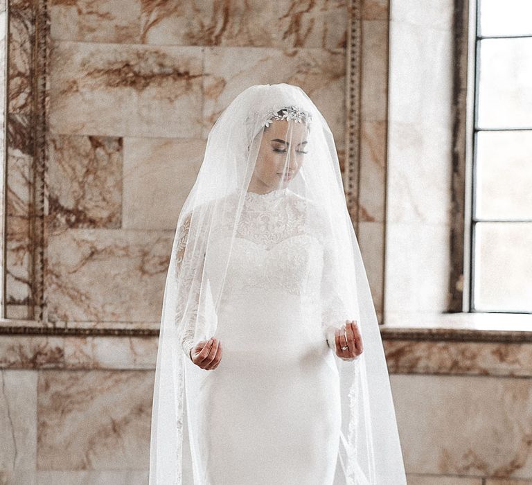 Traditional high neck long sleeve wedding dress and silver accessories