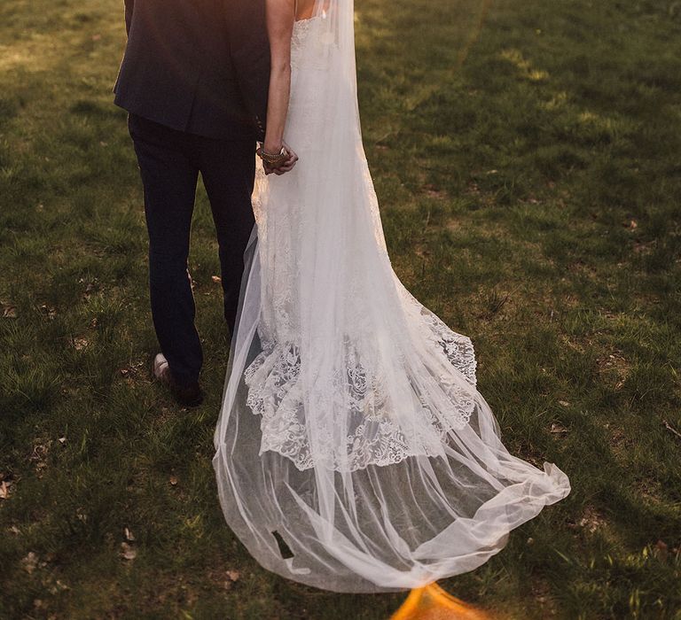 Golden hour wedding photography with the bride and groom sharing a kiss together 