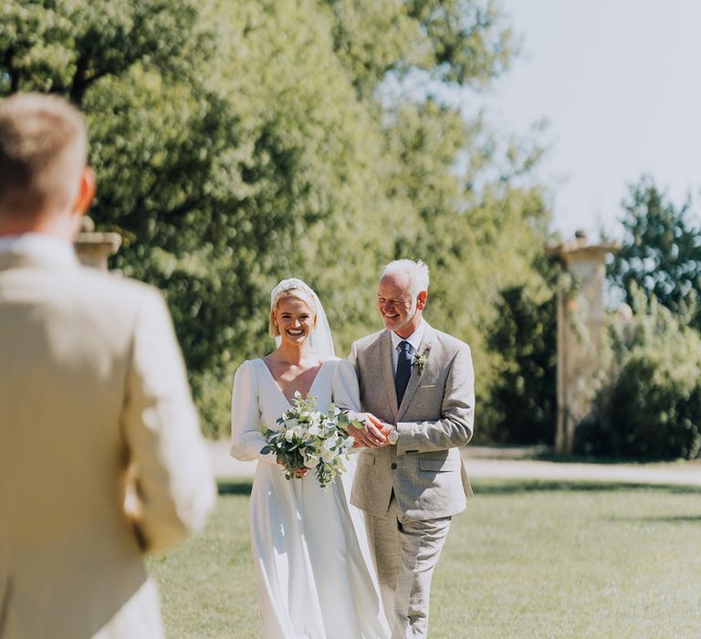 father of the bride walking his daughter down the aisle at French destination wedding 