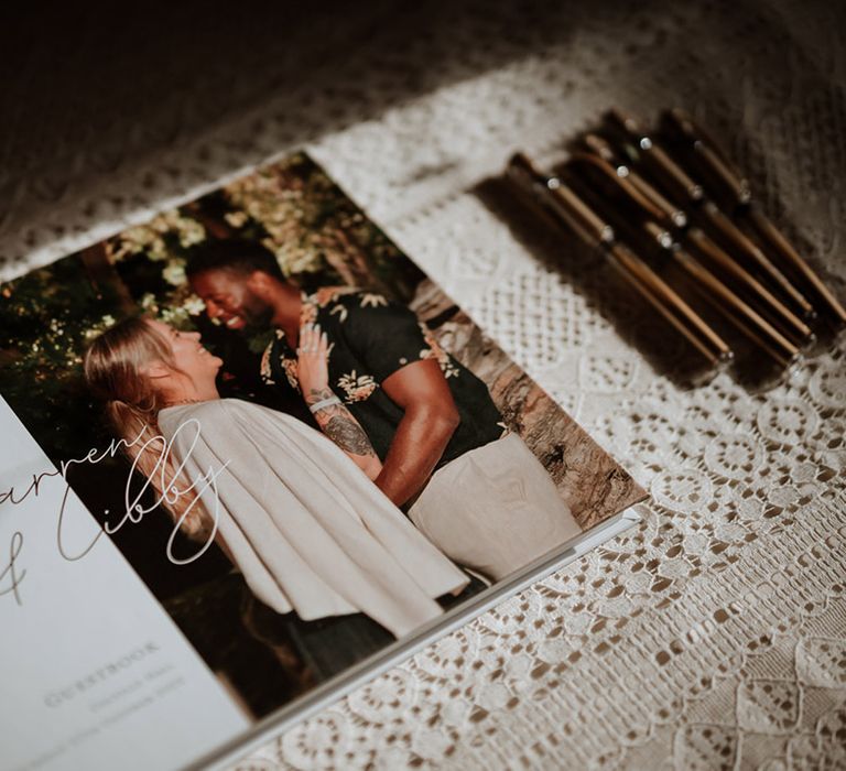 A personalised wedding guestbook laid out for guests to sign and write personal messages 