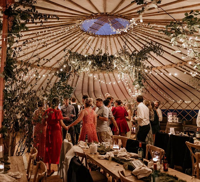 Fairy lights and foliage decorations in the yurt wedding reception at Camp Katur wedding in Yorkshire 