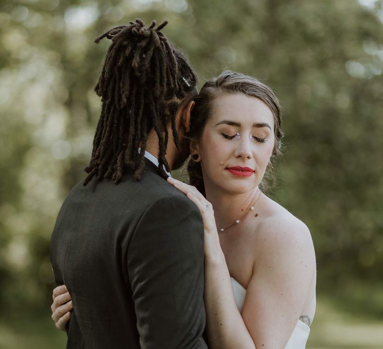 Bride and groom embracing at pink and orange wedding shoot at The Old Rectory wedding venue