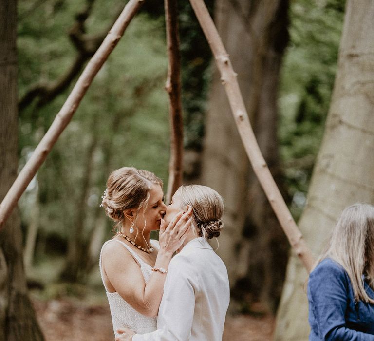 The two brides share their first kiss as a married coupe at their wedding 