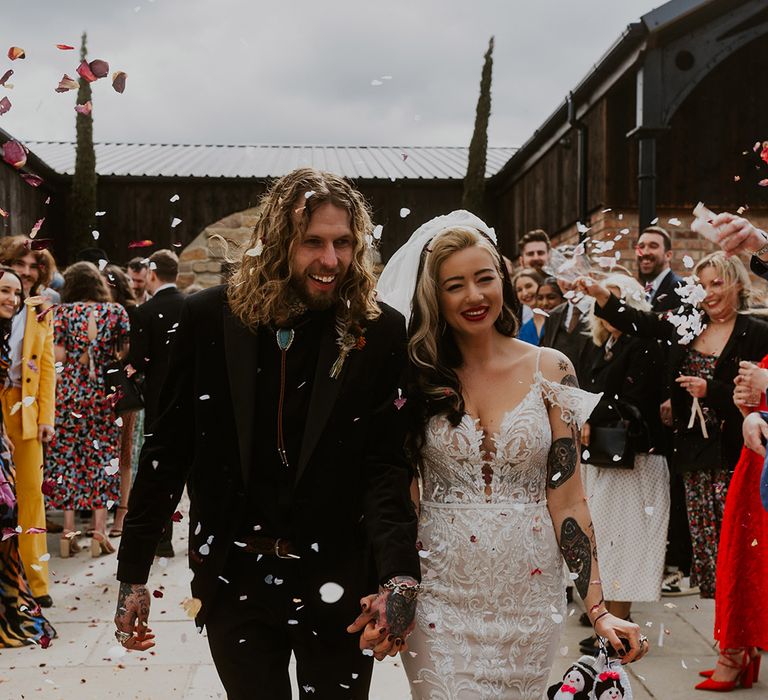 Confetti exit for the bride and groom at their Leicestershire wedding with a Western theme 