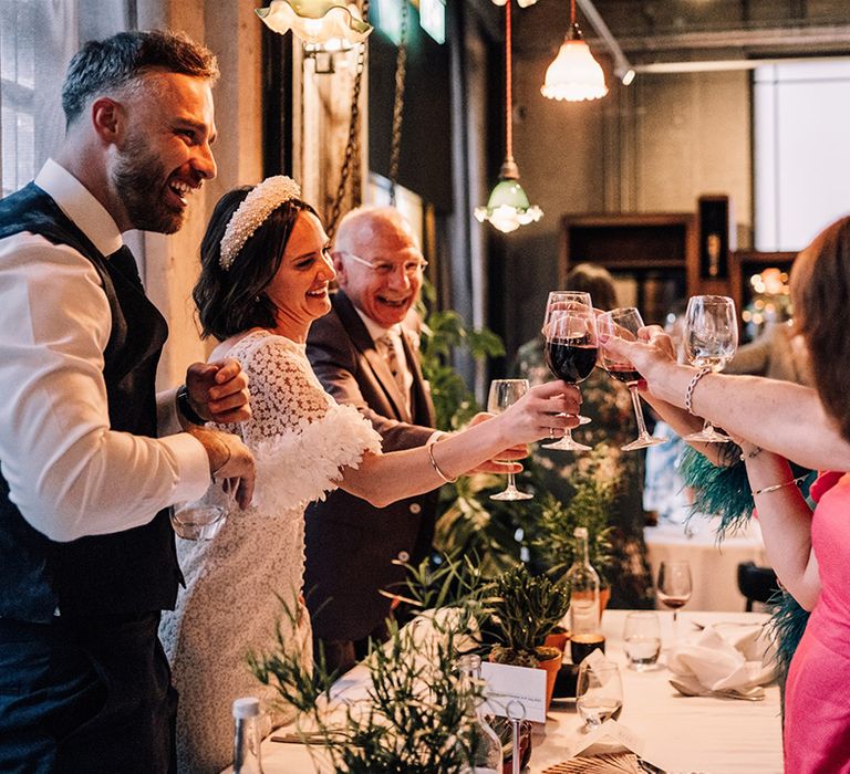 Wedding guests make a toast after the wedding speeches 