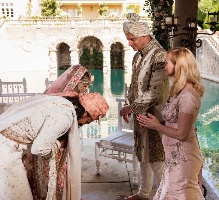 Bride and groom bowing at Hindu wedding ceremony 