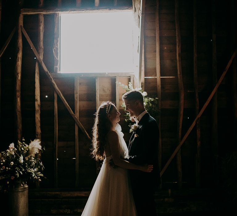 Bride and groom portrait in a barn by Irene Yap Weddings 