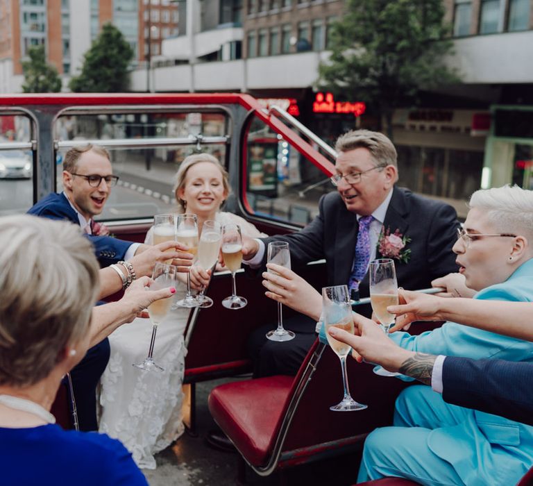 Wedding Guests toast on London wedding bus