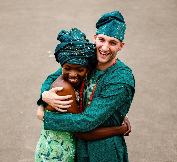 Bride and groom embracing in traditional Nigerian outfits 