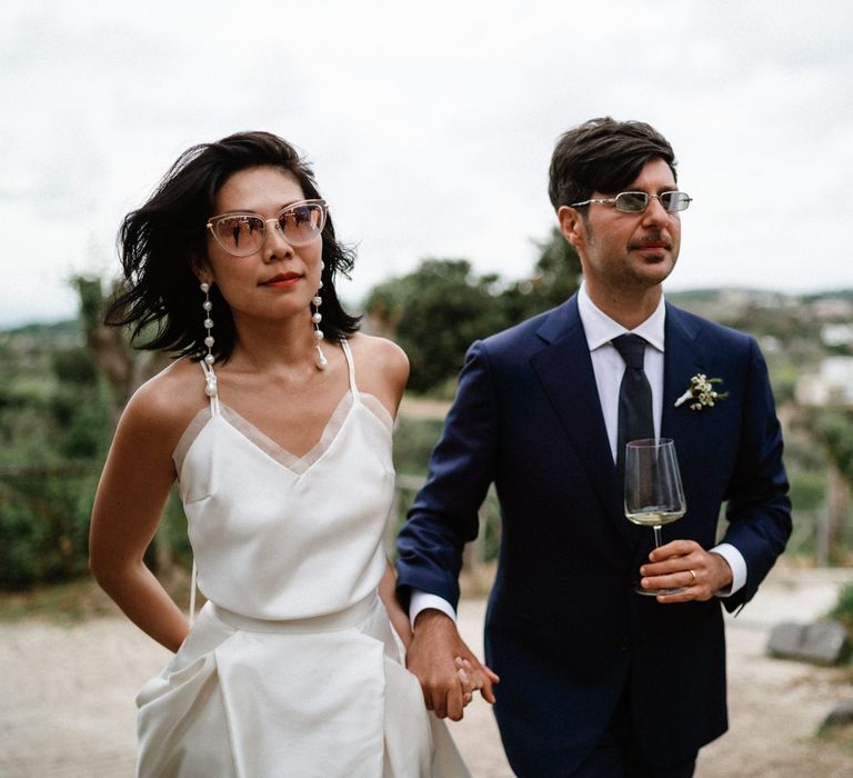 Stylish bride in Halfpenny London skirt and cami with shades and chandelier earrings 