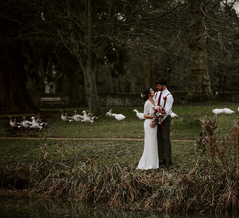 Bride and Groom embrace in gardens