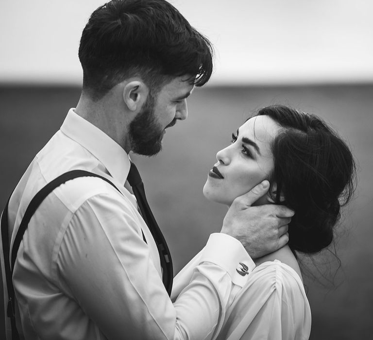 Bride with red lip and Groom look into each others eyes