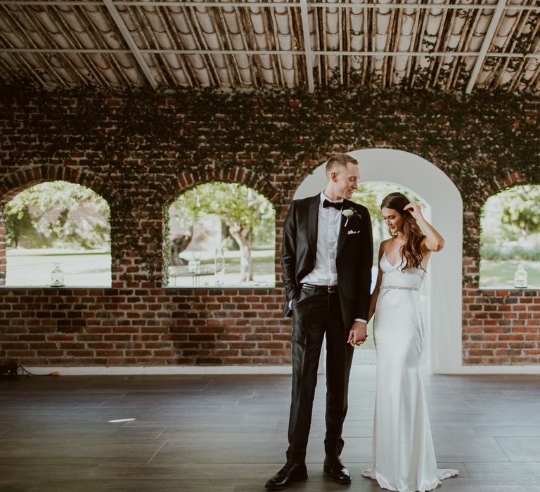 Bride and groom in the rustic barn at Flora Farms