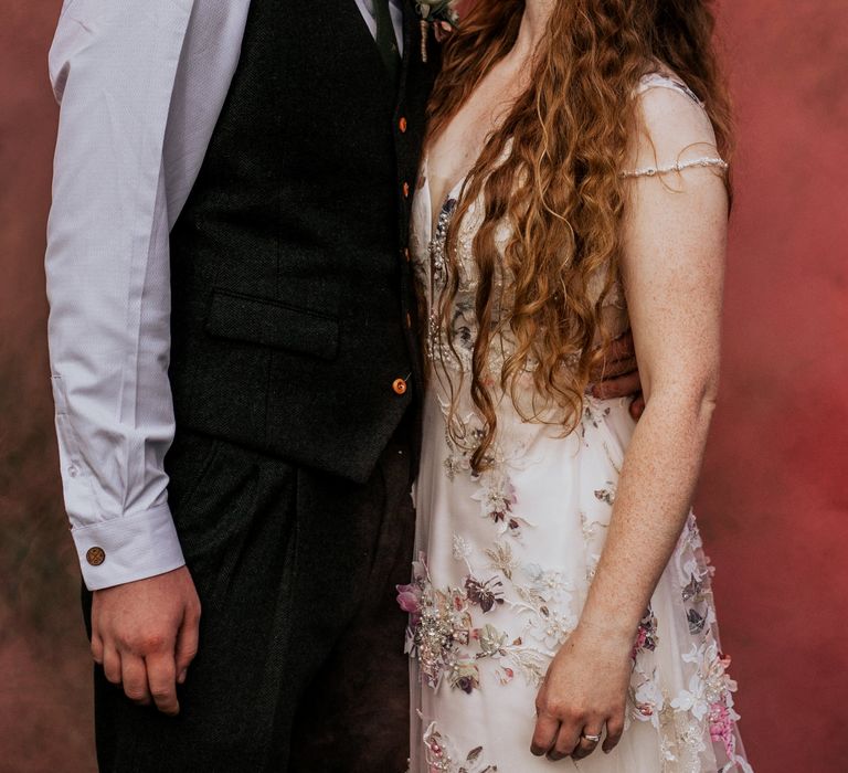 Bride & groom kiss in front of pink smoke bomb 