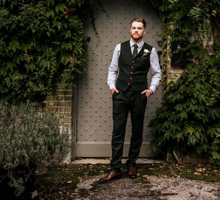 Groom in front of doorway 