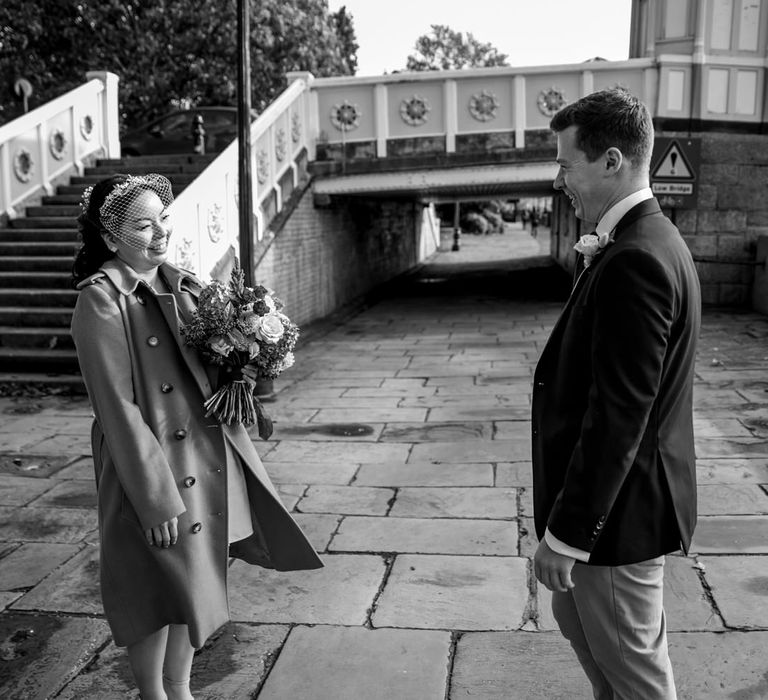 Black and white portrait of the bride and groom first look 