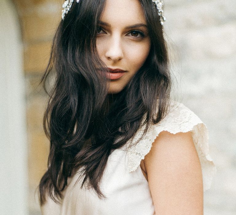 White bride with long brown hair wearing a jewelled headdress in a champagne silk dress | Emma Pilkington Photography