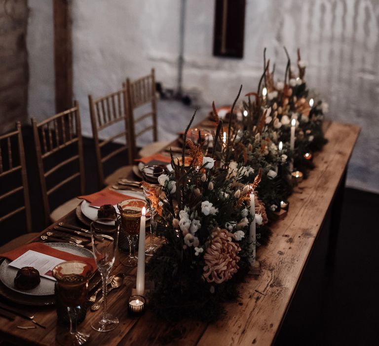 Romantic wedding reception lighting with chandelier installation and taper candles 