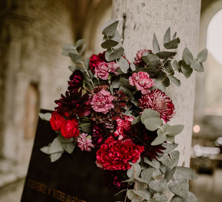 Red rose and carnation flower arrangement with eucalyptus