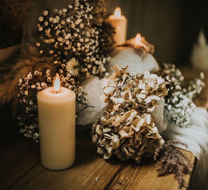 pillar candles and dried hydrangea heads bohemian wedding decor 