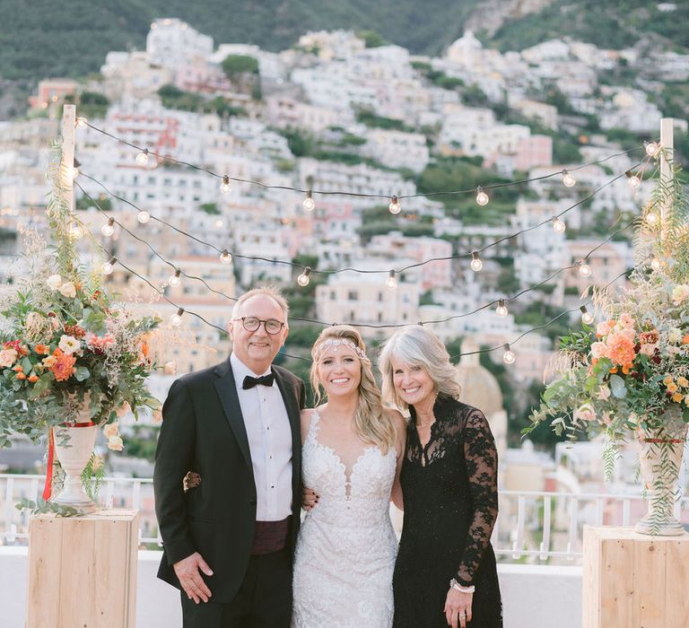 The bride with her parents at the alter after the ceremony