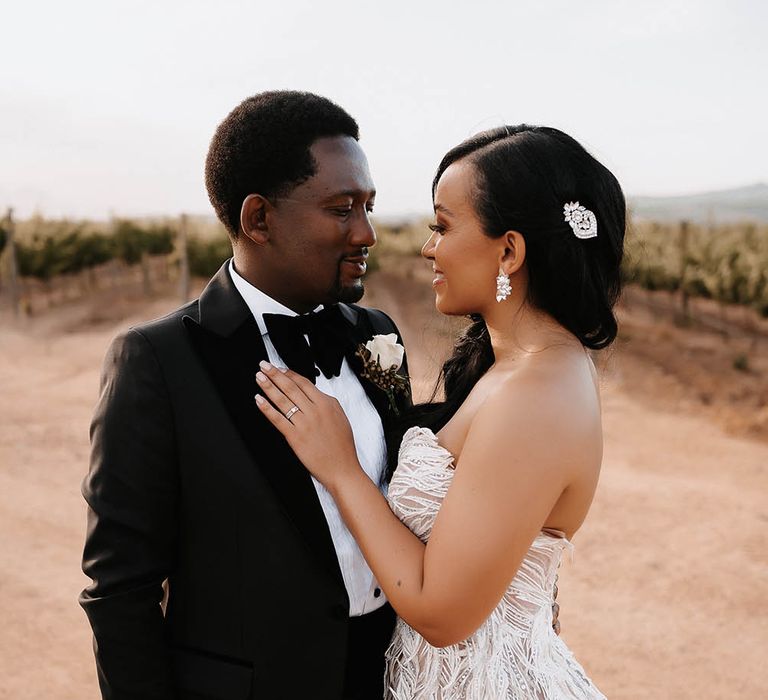 Bride with side swept hear wearing a diamanté hair slide and chandelier earrings