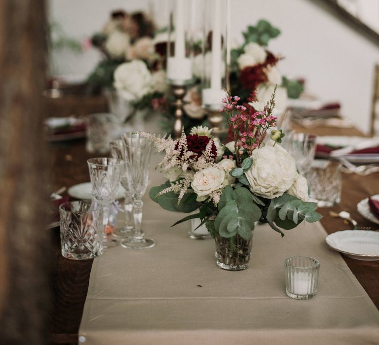 Rustic wooden table setting with floral decor 