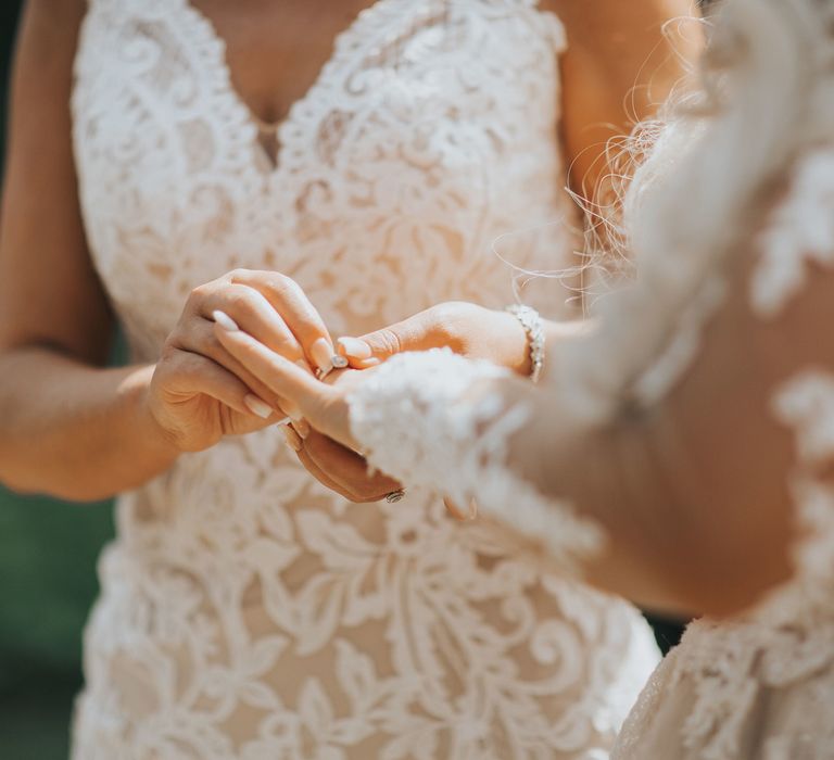 A lesbian couple exchange rings at their wedding ceremony at Crab and Lobster Fairytale Wedding.