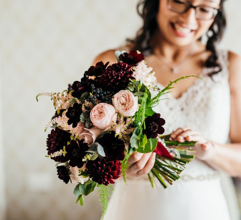 Bride carries Autumnal theme bouquet on wedding day