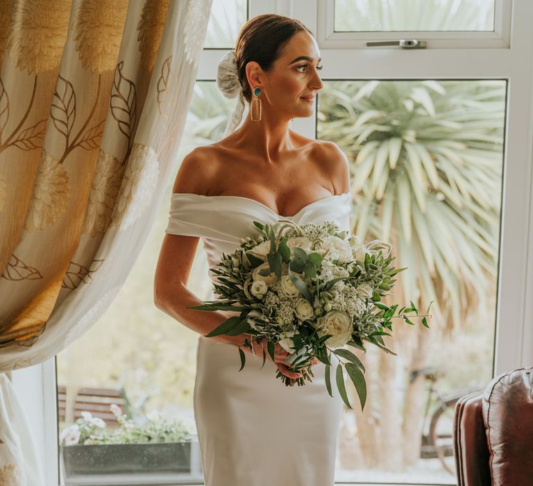 Bride in Halfpenny London wedding dress and bridal bun with veil