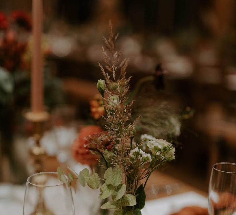 Foliage wedding table decor in glass vase