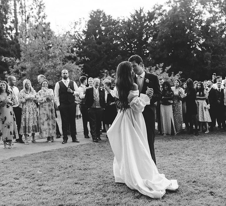 Bride and groom share their first dance at marquee wedding