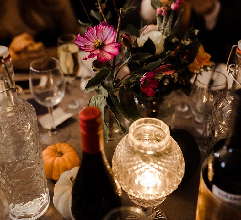 Pink cosmos and berries wedding flower table decor with autumnal pumpkins for intimate micro wedding 