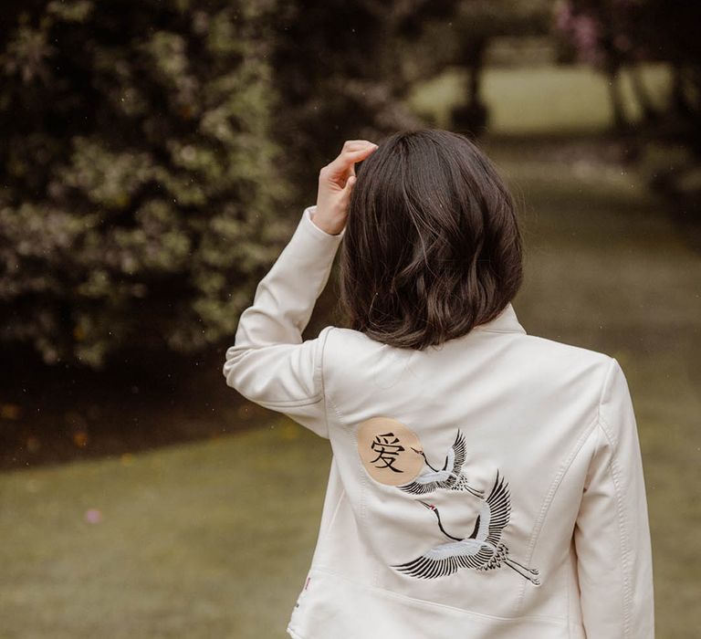 Japanese wedding with bride in a white jacket with East Asian motif 