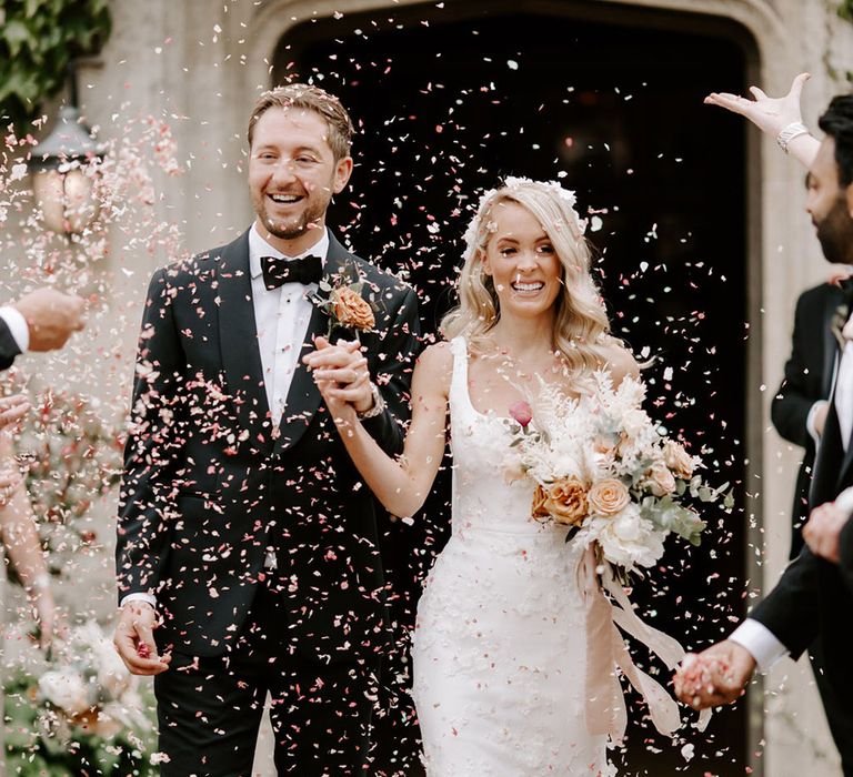 Epic confetti moment for the bride and groom as the exit their ceremony 