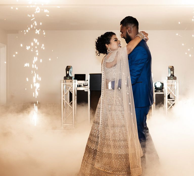 Bride & groom dance during wedding reception surrounded by dramatic dry ice at Froyle Park