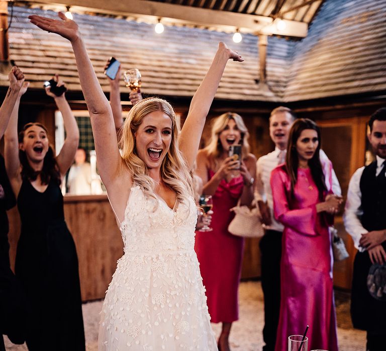 Bride wins the game of Prosecco pong they guests play for wedding entertainment 