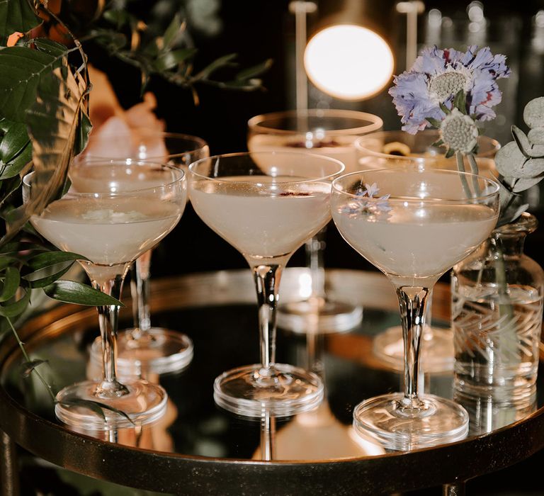 Tray full of wedding cocktails with edible flowers 