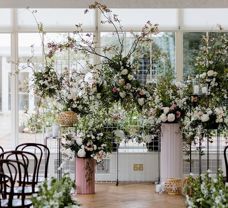 Large floral arrangements to the front of aisle 