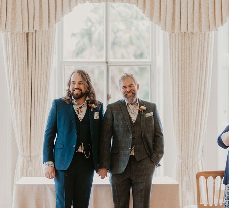 Groom in three piece blue suit and groom in tartan three piece suit complete with pocket watches 