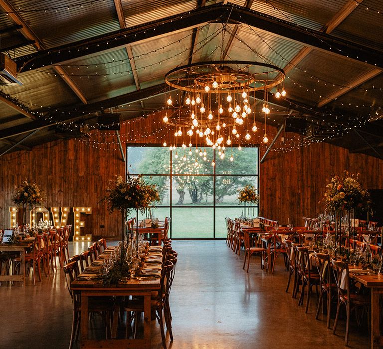 Cosy Silchester Farm wedding venue in Hampshire with hanging festoon light installation and big windows 