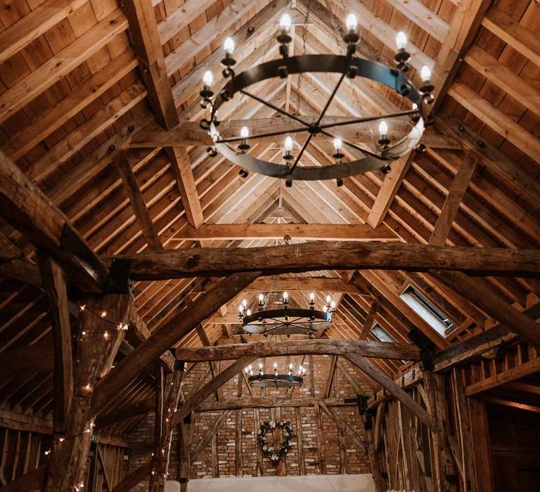 Bassmead Manor Barns wedding venue ceremony room with festoon lighting and fairy lights 