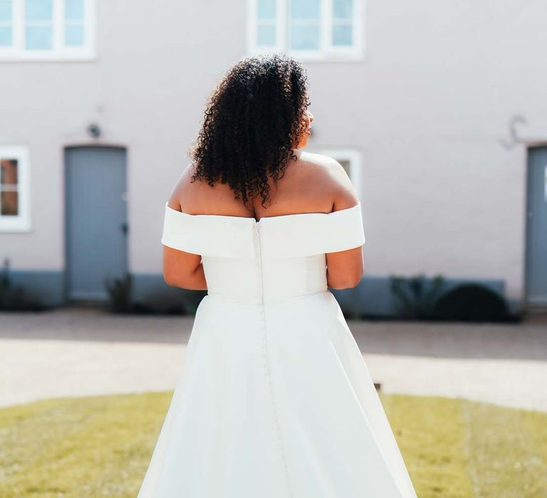 Bride in off the shoulder wedding dress with puddle train at Rackleys Barn